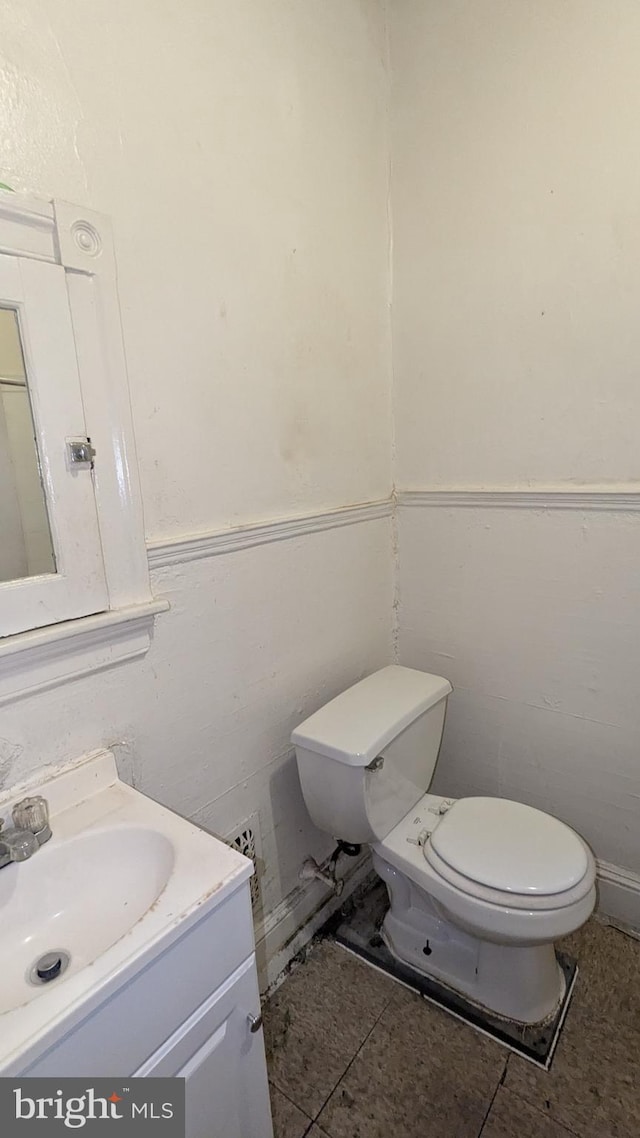 bathroom featuring vanity and toilet