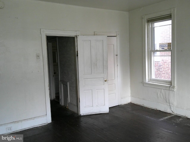 empty room featuring dark wood-type flooring