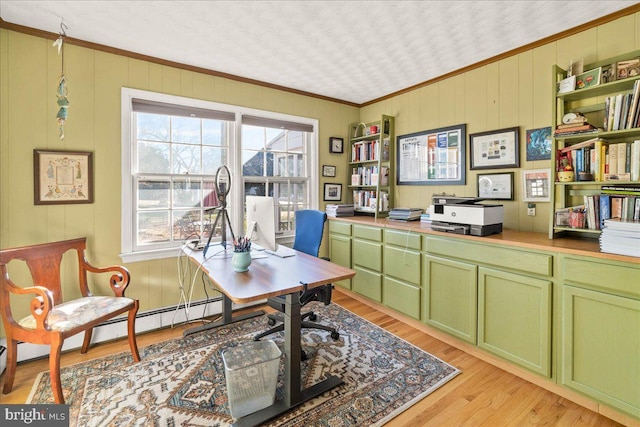 office area featuring a baseboard heating unit, light hardwood / wood-style floors, and crown molding