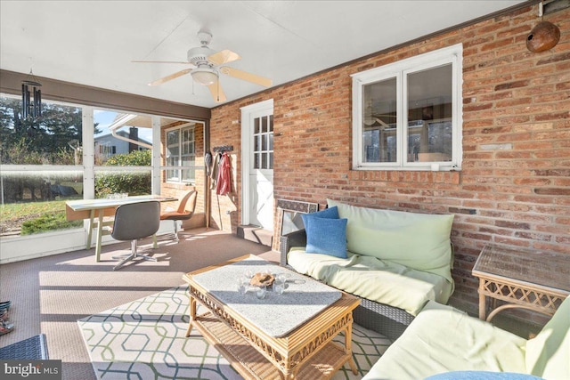 sunroom featuring ceiling fan