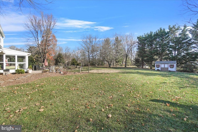 view of yard featuring an outbuilding and a sunroom