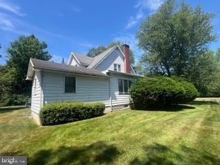 view of home's exterior with a yard