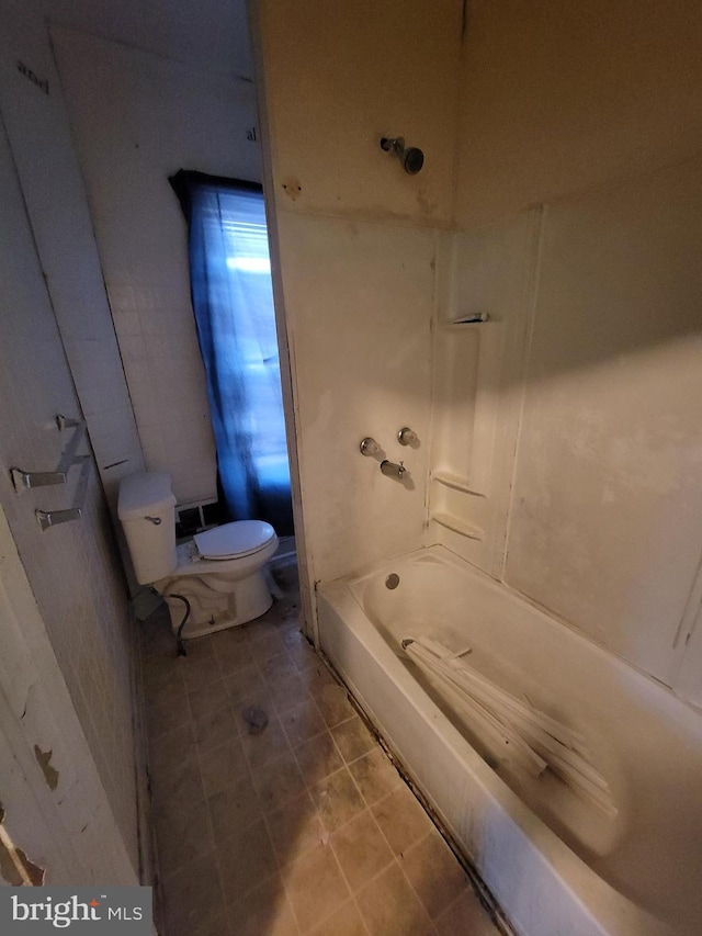 bathroom featuring shower / bathing tub combination and toilet