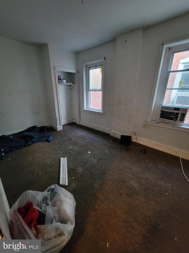 bedroom featuring cooling unit and multiple windows