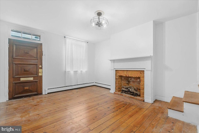 unfurnished living room with light hardwood / wood-style floors and a baseboard radiator