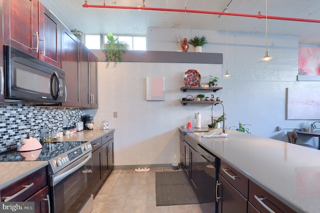 kitchen featuring decorative backsplash, pendant lighting, light tile patterned flooring, and black appliances