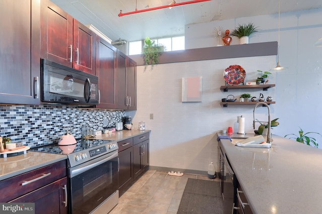 kitchen featuring light stone countertops, backsplash, stainless steel range with electric stovetop, and light tile patterned flooring