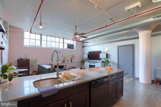 kitchen with dark brown cabinetry, ceiling fan, sink, light stone countertops, and black dishwasher