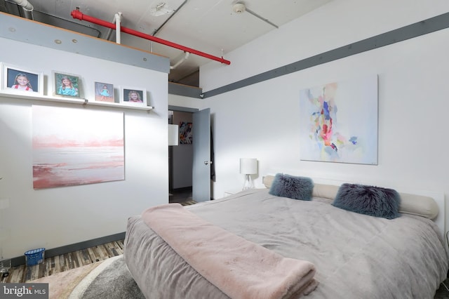 bedroom with dark wood-type flooring