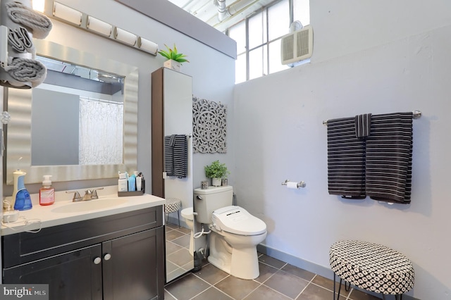 bathroom with tile patterned flooring, vanity, a wall mounted air conditioner, and toilet