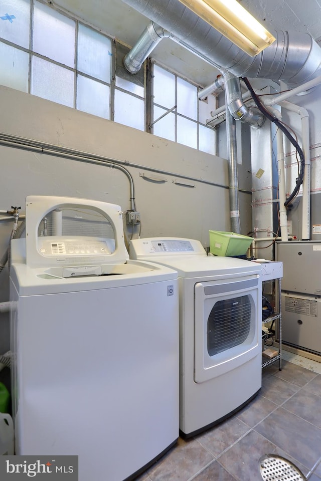 washroom featuring tile patterned flooring and washer and clothes dryer