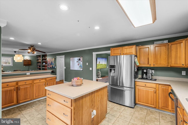 kitchen with appliances with stainless steel finishes, a kitchen island, hanging light fixtures, and ornamental molding