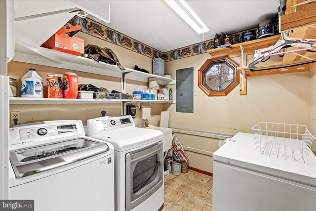 clothes washing area featuring washing machine and dryer and electric panel