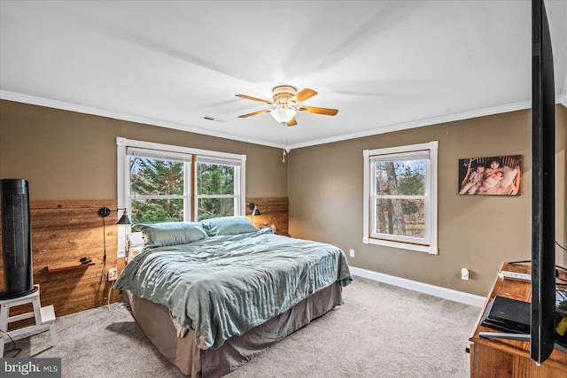 carpeted bedroom featuring multiple windows, ceiling fan, and crown molding