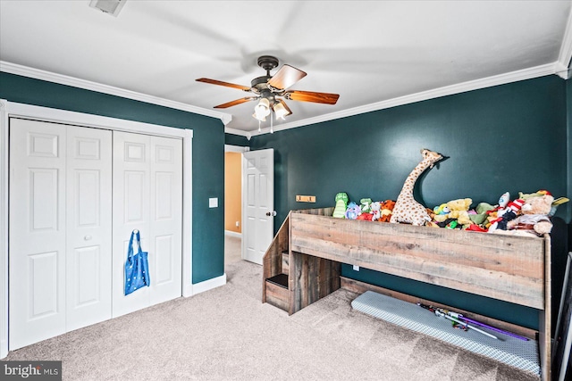 bedroom with light carpet, a closet, ceiling fan, and crown molding