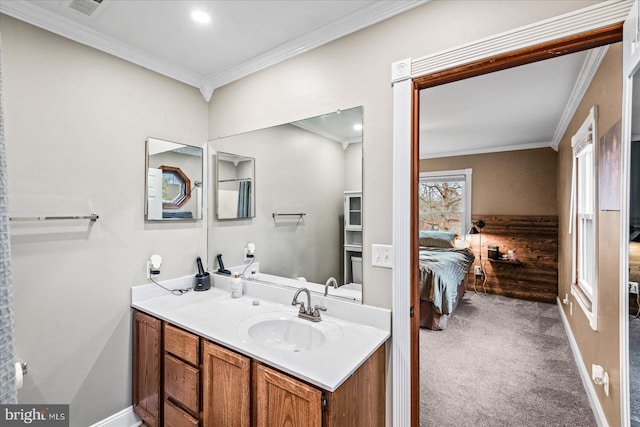 bathroom featuring crown molding and vanity