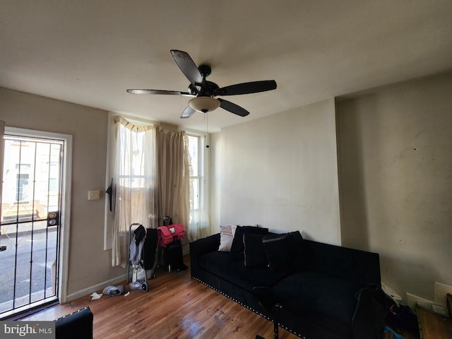 living room with hardwood / wood-style floors and ceiling fan