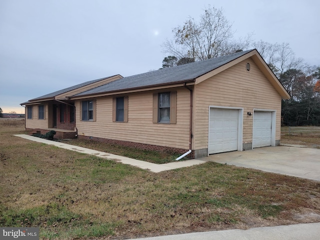 view of front of property with a garage and a front lawn