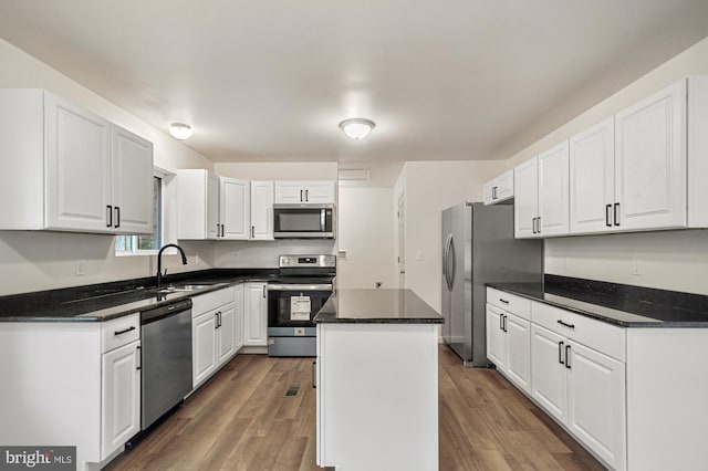 kitchen featuring white cabinetry, a kitchen island, and stainless steel appliances