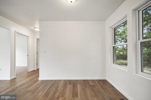 empty room featuring dark hardwood / wood-style flooring