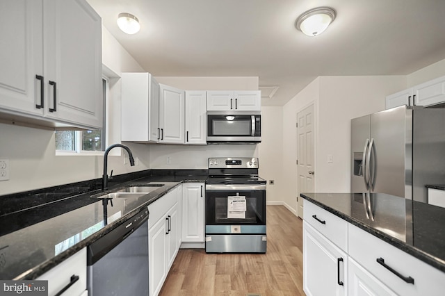 kitchen featuring sink, white cabinets, and appliances with stainless steel finishes