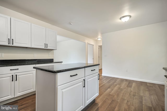 kitchen featuring white cabinets, dark hardwood / wood-style floors, and a kitchen island