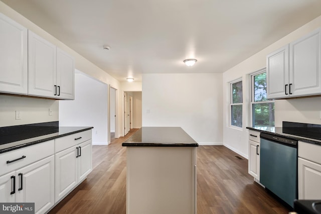 kitchen featuring white cabinetry, dishwasher, a kitchen island, and dark wood-type flooring