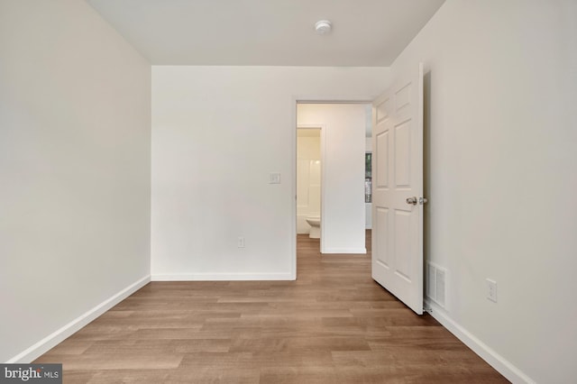 empty room with light hardwood / wood-style flooring