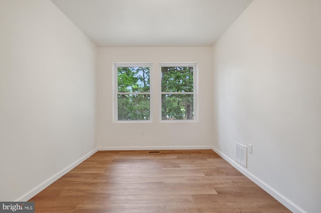 spare room featuring light hardwood / wood-style floors