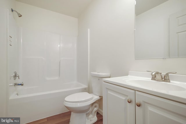 full bathroom with vanity, toilet, wood-type flooring, and bathing tub / shower combination