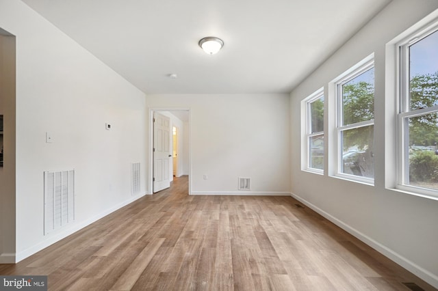 unfurnished room with light wood-type flooring