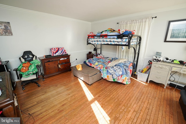 bedroom featuring hardwood / wood-style flooring and ornamental molding