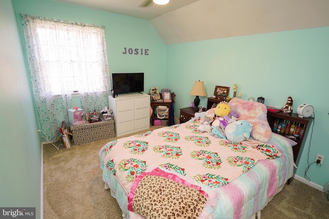 carpeted bedroom with vaulted ceiling and ceiling fan