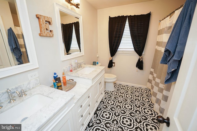 bathroom featuring tile patterned flooring, vanity, and toilet