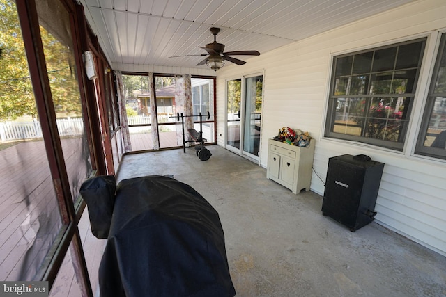 sunroom / solarium featuring ceiling fan and wooden ceiling