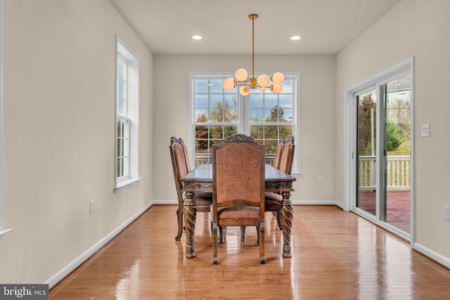 dining room with a chandelier and light wood-type flooring