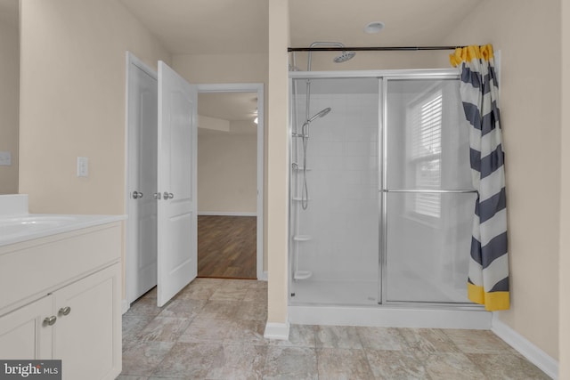 bathroom featuring vanity and tiled shower