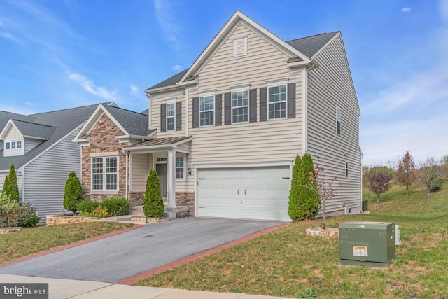 view of property featuring a front yard and a garage