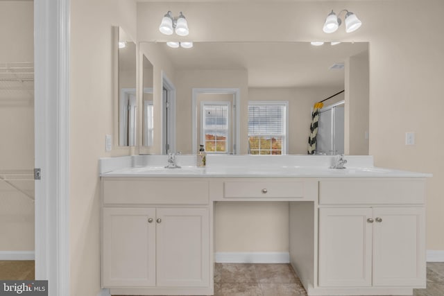 bathroom featuring tile patterned floors, vanity, and an enclosed shower