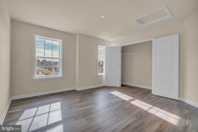 unfurnished bedroom featuring hardwood / wood-style floors and a closet