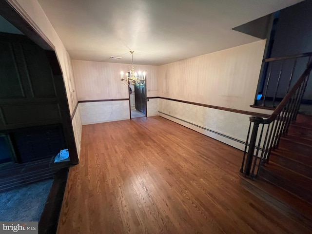 dining area featuring a chandelier and wood-type flooring