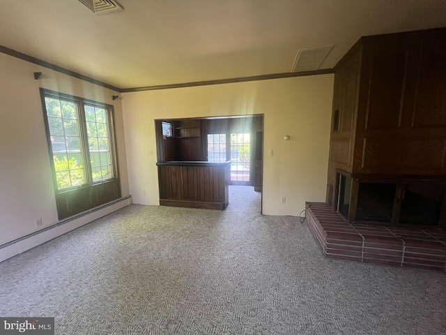 unfurnished living room with carpet floors, crown molding, a wealth of natural light, and a baseboard radiator