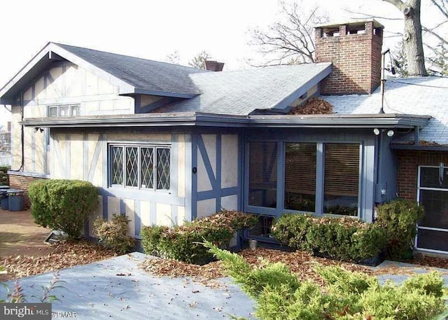 back of house featuring a sunroom