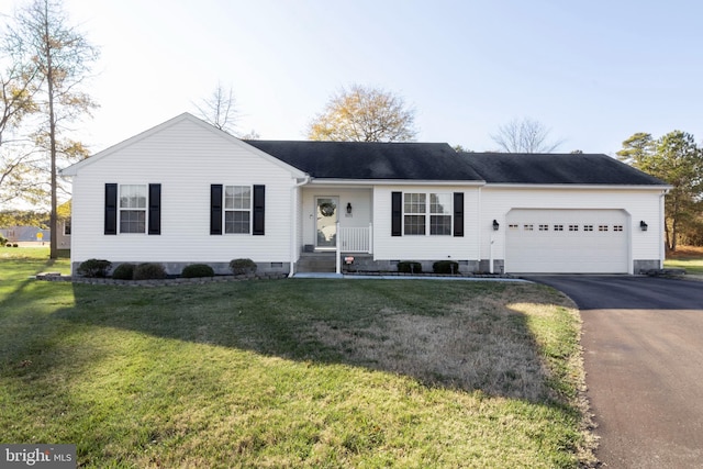 ranch-style house featuring a front yard and a garage