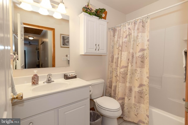 full bathroom with tile patterned flooring, shower / tub combo with curtain, vanity, and toilet