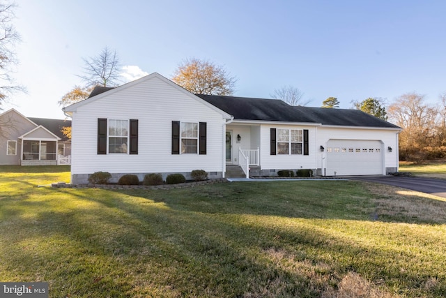 ranch-style house featuring a garage and a front yard