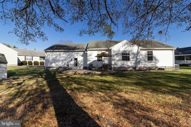 rear view of house with a patio area and a yard