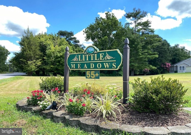 community / neighborhood sign with a yard