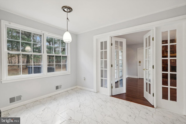 unfurnished dining area featuring french doors, a healthy amount of sunlight, and hardwood / wood-style floors