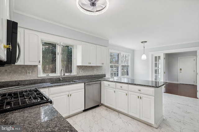 kitchen featuring dishwasher, backsplash, dark stone counters, white cabinets, and sink